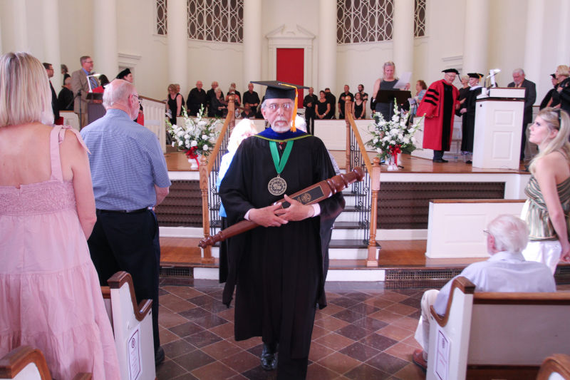Dr. Robert Seufert, Professor Emeritus of English, Leads the 2020 Graduates and Platform Party Out with the College Mace for the Last Time