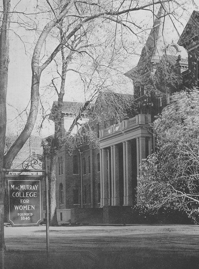 A photo showing the front of Main Hall with a sign in the lawn reading "MacMurray College for Women — Founded 1846".