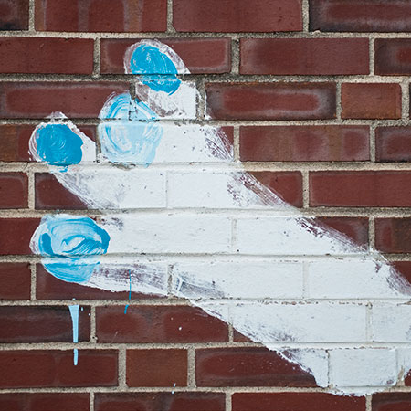 A photo of one of the Michalson Monster's footprints painted on the side of a brick building.